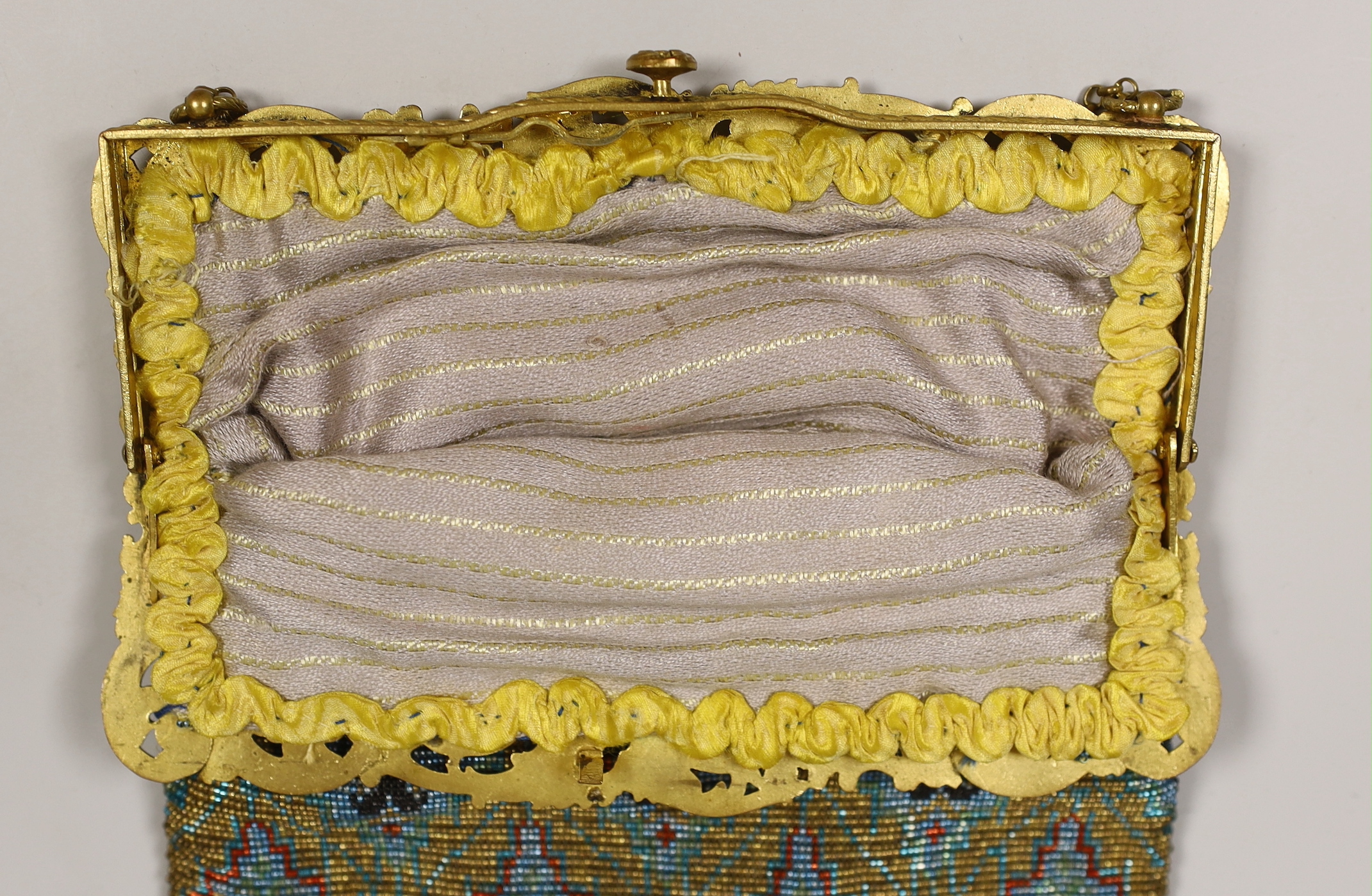 A late 19th century French gilt metal mounted coloured beaded evening bag, 17cm wide
